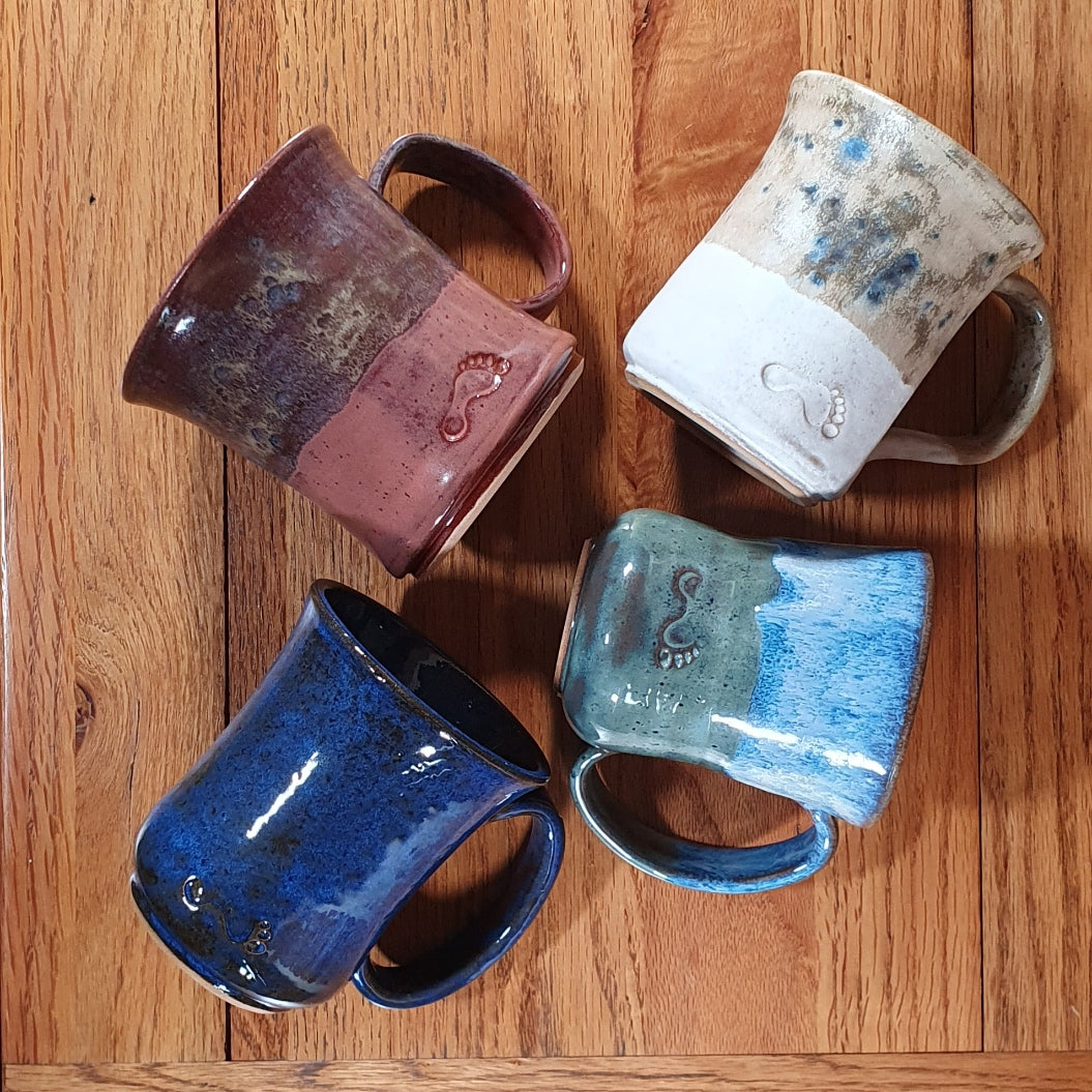 Group of hand made pottery mugs.