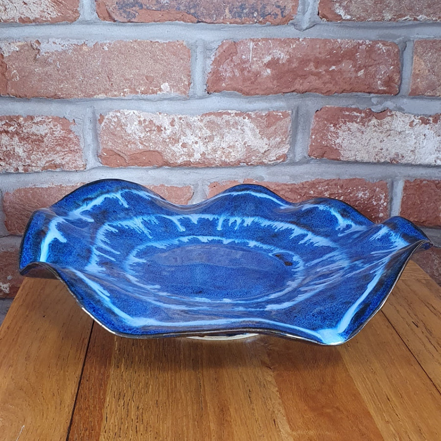Large blue decorative wavey handmade pottery bowl.