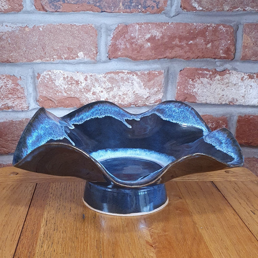 Medium sized blue decorative wavey handmade pottery bowl.