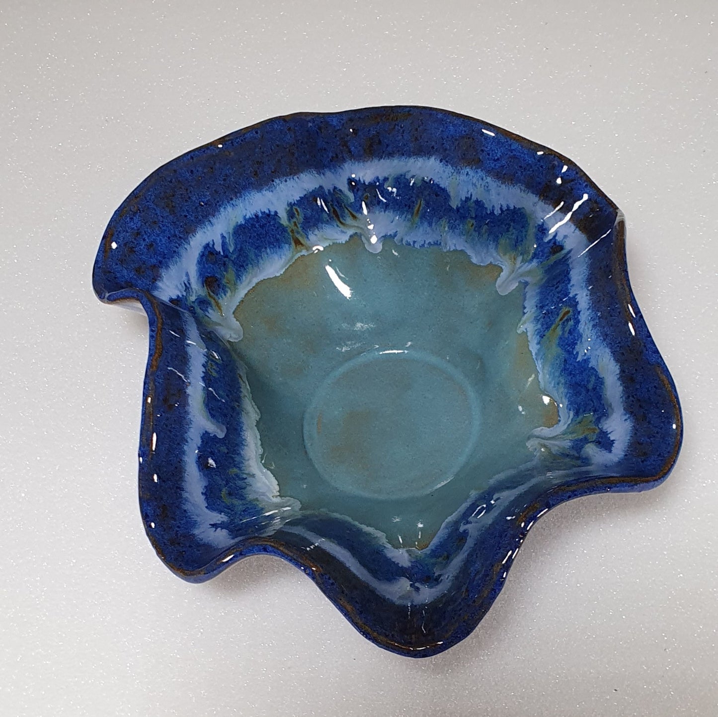 Small blue wavey handmade pottery bowl.