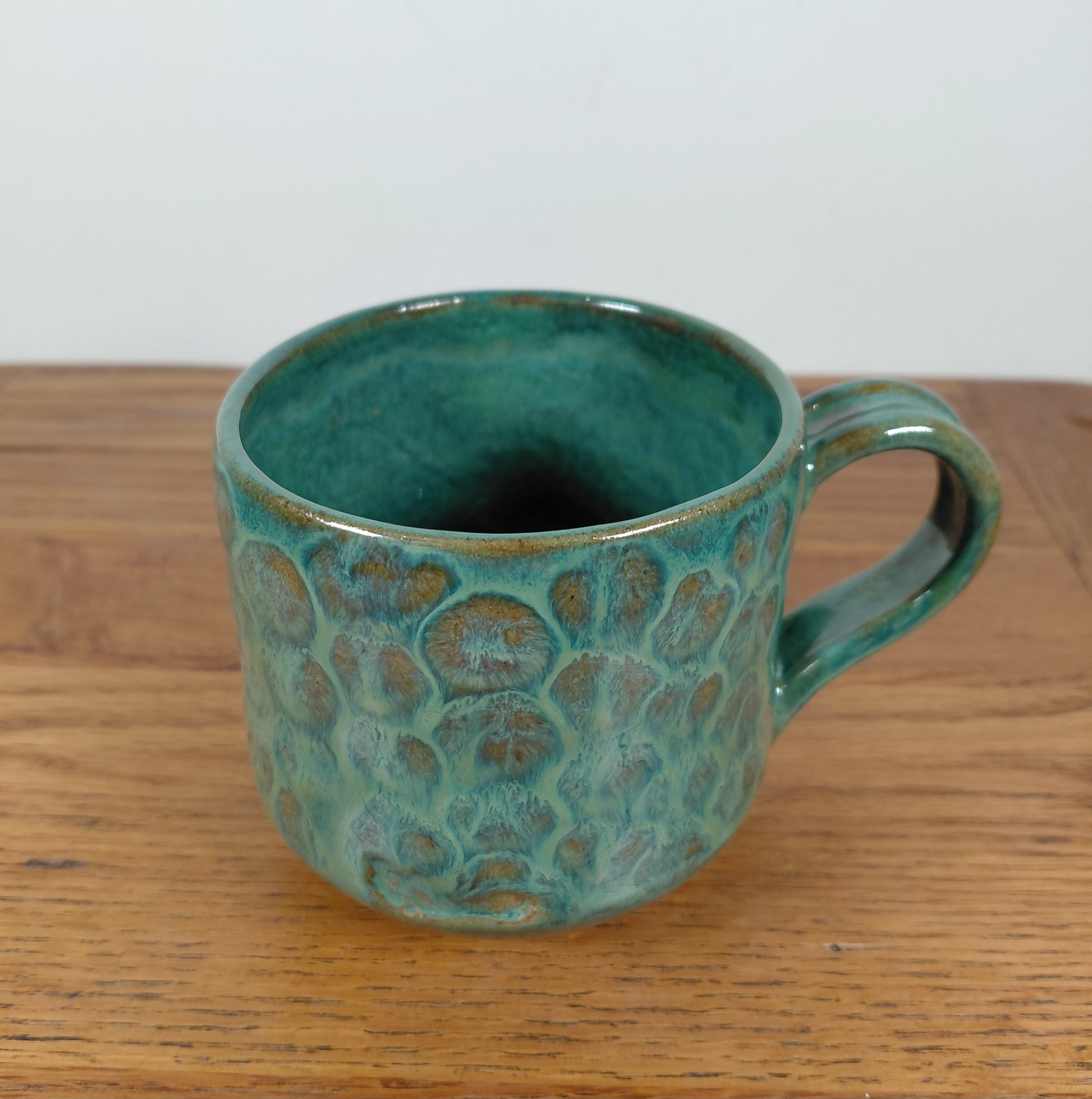 Ceramic hand made bowl with a green mosaic effect glaze
