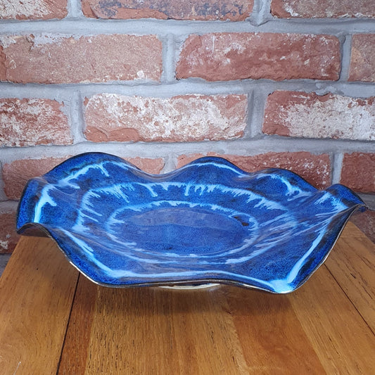 Large blue decorative wavey handmade pottery bowl.